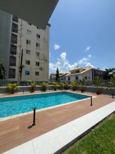 a swimming pool in front of a building at D'Empire in Lekki