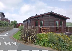 a wooden cabin on the side of a road at Bossiney Bay in Tintagel