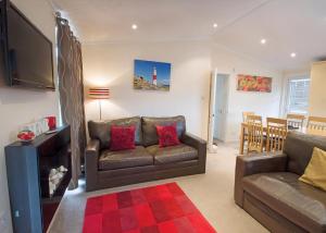 a living room with a couch and a television at Bossiney Bay in Tintagel