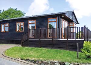 a black modular home with a large deck at Bossiney Bay in Tintagel
