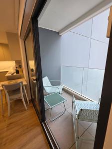 a balcony with two chairs and a table at Brand New - Studio Apartment - Self Catering in Gibraltar +4 photos