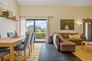 a living room with a couch and a table at Sweet Orchard Escape - By Wehost in Porto Moniz