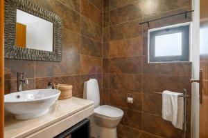 a bathroom with a sink and a toilet at Sweet Orchard Escape - By Wehost in Porto Moniz +23 photos