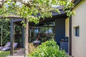 a glass extension to a house at Sweet Orchard Escape - By Wehost in Porto Moniz