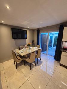 a kitchen and dining room with a table and chairs at Central House Kenmare in Kenmare