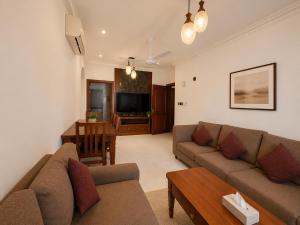 a living room with a couch and a table at hotel Alsalam suites in Salalah