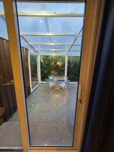 a glass door leading to a patio with a table at Central House Kenmare in Kenmare