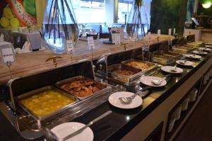 a buffet line with many trays of food at Hotel San Marcos Grand in Culiacán
