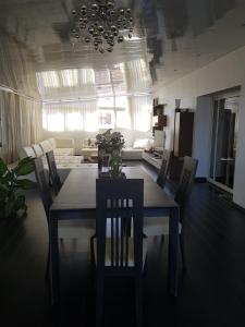 a dining table and chairs in a living room at le jasmin in El Achour +28 photos