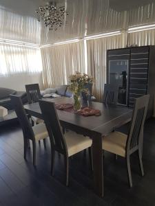 a dining room table and chairs with a table and a vase at le jasmin in El Achour