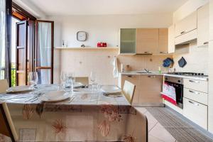 a kitchen with a table with wine glasses on it at Appartamento Manerbio in Manerbio +11 photos