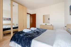a bedroom with a large bed and a mirror at Appartamento Manerbio in Manerbio