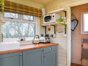 a kitchen with a sink and a microwave at The Rams Rest - Uk48823 in Kirby Misperton +5 photos