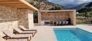 a patio with chairs and a swimming pool at TAO House in Ferma