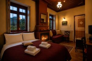 a bedroom with a bed with two towels on it at Villa Georgia in Vitsa