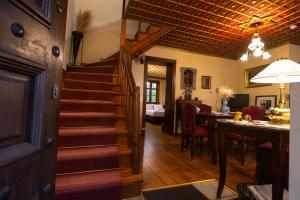 a staircase in a living room with a dining room at Villa Georgia in Vitsa