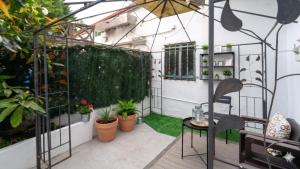 a patio with plants and a table and chairs at Monte la Torre in Santander