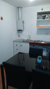 a kitchen with a sink and a counter top at Cabañas M y M Frutillar in Frutillar