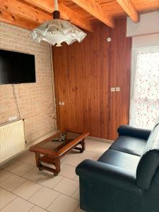 a living room with a couch and a coffee table at Le Gite Zelya in Bourbourg