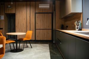 a kitchen with a table and two chairs and a counter at Готель Бутік Сіті in Kropyvnytskyi