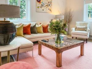 a living room with a couch and a table at Elm Tree House - Uk51762 in Landford