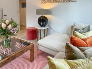 a living room with a couch and a table at Elm Tree House - Uk51762 in Landford