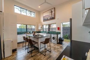 a kitchen with a table and chairs in a room at Wild Villas in Victoria Falls
