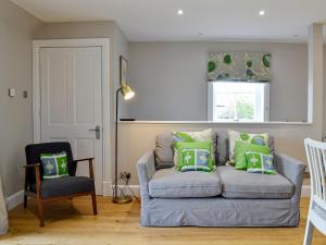 a living room with a couch and a chair at Grange Loft - Uk31594 in Dundee