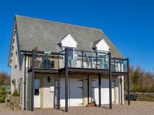 a house with a balcony on the side of it at Grange Loft - Uk31594 in Dundee