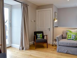 a living room with a couch and a chair at Grange Loft - Uk31594 in Dundee +17 photos