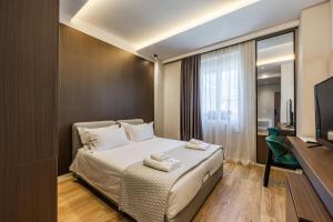 a hotel room with a bed and a television at Hotel Aquila D in Durrës +128 photos