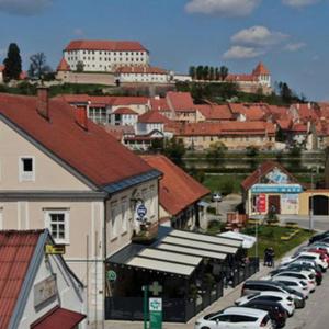 a city with cars parked in a parking lot at Apartma na Grad in Ptuj