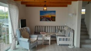 a living room with a couch and a table at 'Seeperle' am Strand des Kummerower Sees in Verchen