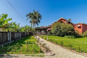 a house with a garden in front of a house at Beautiful Pousada in the middle of nature in Bombinhas in Canto Grande