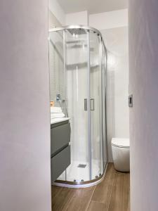 a glass shower in a bathroom with a toilet at Arpi Uno in Foggia +31 photos