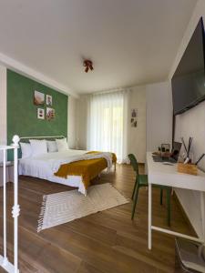 a bedroom with a bed and a desk and a television at Arpi Uno in Foggia