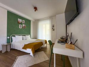 a bedroom with a bed and a table and a desk at Arpi Uno in Foggia