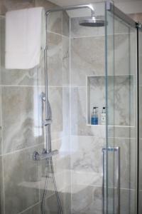 a shower in a bathroom with a glass door at Hidden Gem - Charmouth Dorset in Charmouth +82 photos