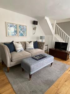 a living room with a couch and a coffee table at Hidden Gem - Charmouth Dorset in Charmouth