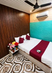 a bedroom with a bed with flowers on a table at Hotel Akasa View in Mumbai
