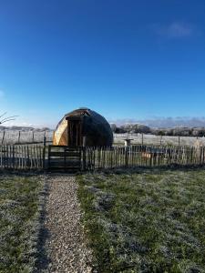 a yurt in a field next to a fence at Dôme géodésique in Brie +3 photos