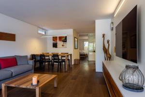 a living room with a couch and a table at Buchtoase in Spiez