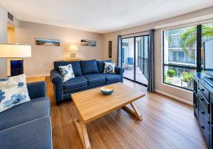 a living room with a couch and a table at Siesta Key Beach - 2 Bedroom - 3 Beds - 3 Bathroom Duplex with Heated Swimming Pool in Siesta Key