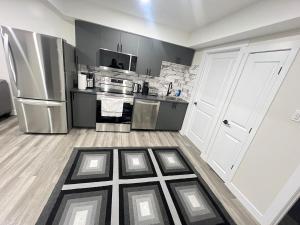 a kitchen with a refrigerator and a counter top at Purplecherry Haven in Regina