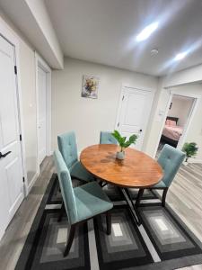 a dining room with a wooden table and green chairs at Purplecherry Haven in Regina