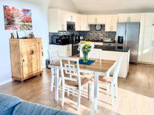 a kitchen and dining room with a table and chairs at Cocoplum #8 Condo in George Town