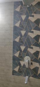 a bathroom with a tiled floor with a wall at Orchard Suite in VÄngaon +4 photos