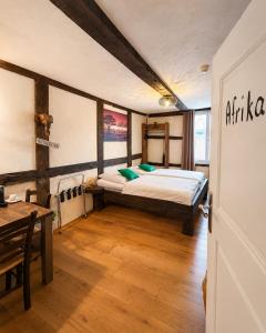 a bedroom with a bed and a table in it at Hotel Pemü in Arnsberg +22 photos