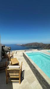 a patio with a pool and chairs and the ocean at Caldera Serenity - Small Luxury Villas in Imerovigli