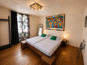 a bedroom with a bed and a painting on the wall at Hotel Pemü in Arnsberg